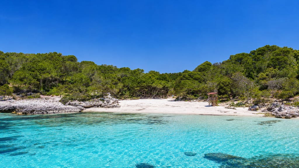 Cala en Turqueta, pale sand and turquoise water in southern Ciutadella, Menorca