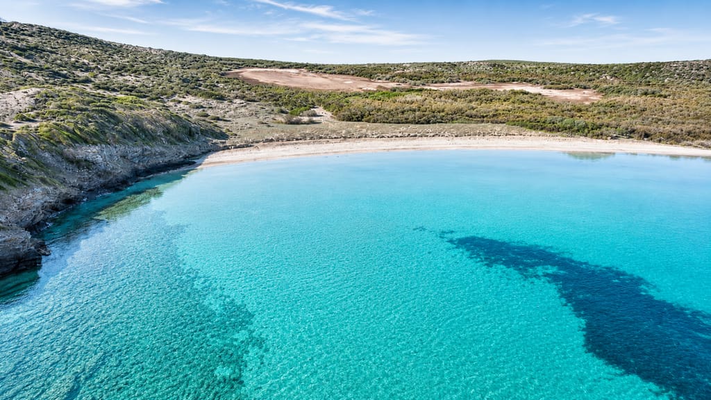 The Camí de Cavalls coastal path running above a Menorcan cove