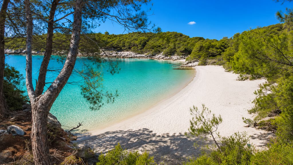 Cala Turqueta, one of the white-sand, turquoise-water coves on the south coast of Menorca